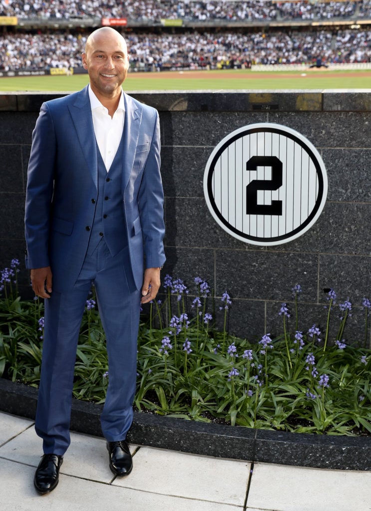 Former New York Yankees captain Derek Jeter poses next to his number in Monument Park during the retirement ceremony of Jeter's jersey #2 at Yankee Stadium. Courtesy of Elsa/Getty Images.