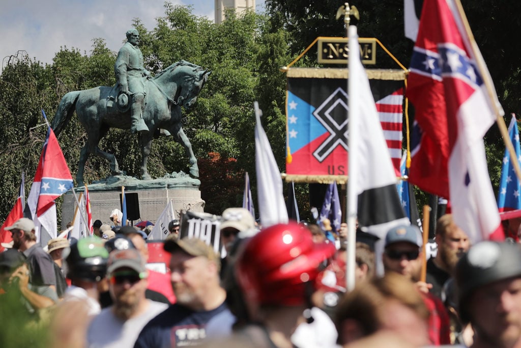 The statue of Confederate General Robert E. Lee stands behind a crowd of hundreds of white nationalists, neo-Nazis and members of the "alt-right" during the "Unite the Right" rally August 12, 2017 in Charlottesville, Virginia. Photo by Chip Somodevilla/Getty Images.