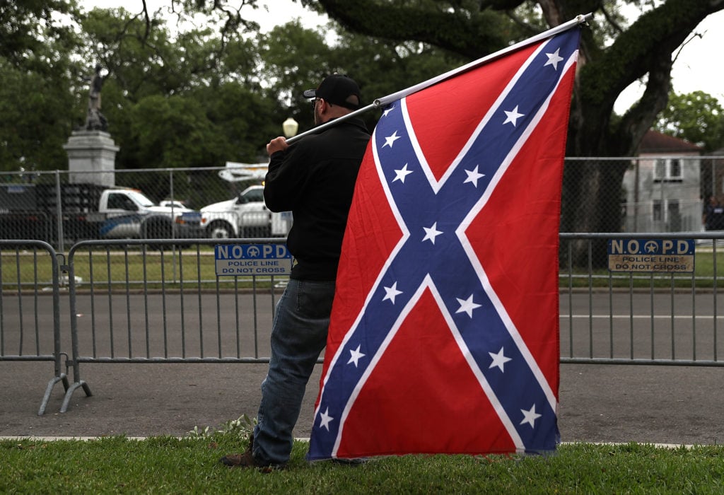 Protesters holds a Conferderate flag across the street from the Jefferson Davis monument on May 4, 2017 in New Orleans, Loiusiana. Photo by Justin Sullivan/Getty Images.