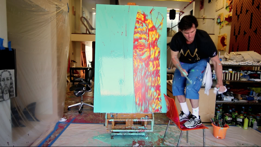 Jim Carrey at work in his studio in the documentary <Em>I Needed Color</em>. Screenshot courtesy of Signature Gallery Group.