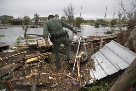 A US Border Patrol agent searches for survivors in the wake of Hurricane Harvey near Rockport, Texas, August 27, 2017. Courtesy of the National Endowment for the Humanities. 