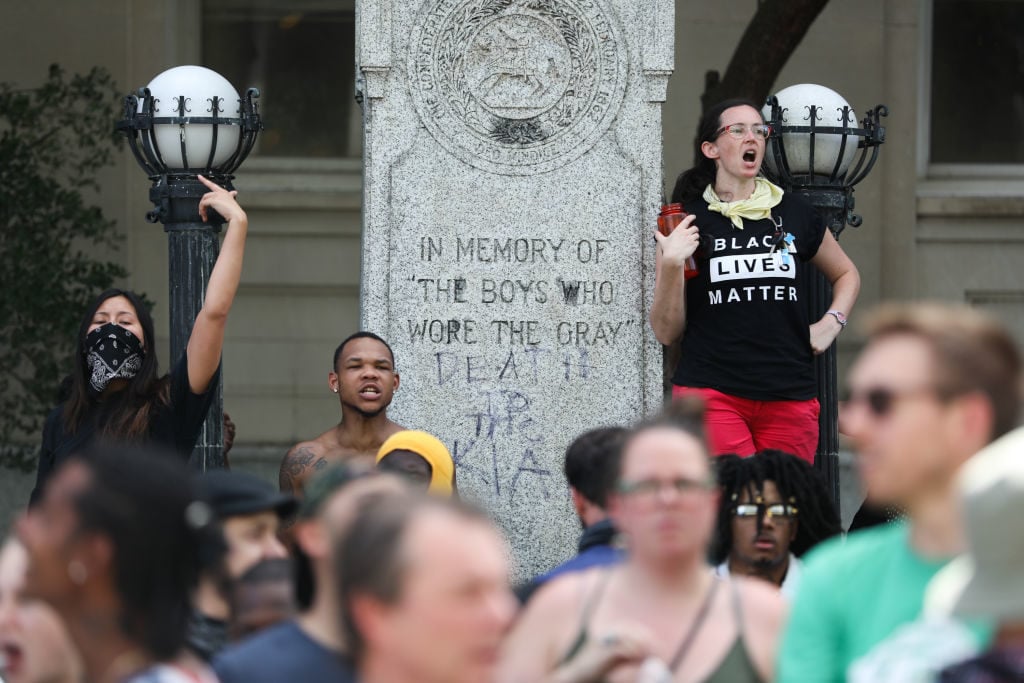 Protesters gather in front of the old Durham County Courthouse where days earlier a confederate statue was toppled by demonstrators, in Durham, North Carolina, on August 18, 2017. Photo credit should read Logan Cyrus/AFP/Getty Images.