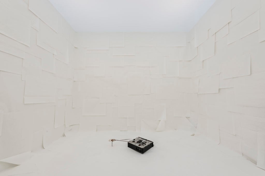 Marina Abramovic, <i>White Space</i> (1972), a sound installation consisting of the amplified sound of blank magnetic tape within a circular white papered space, and Instructions for the public that read: "Enter the white space. Listen." Courtesy Lisson Gallery 