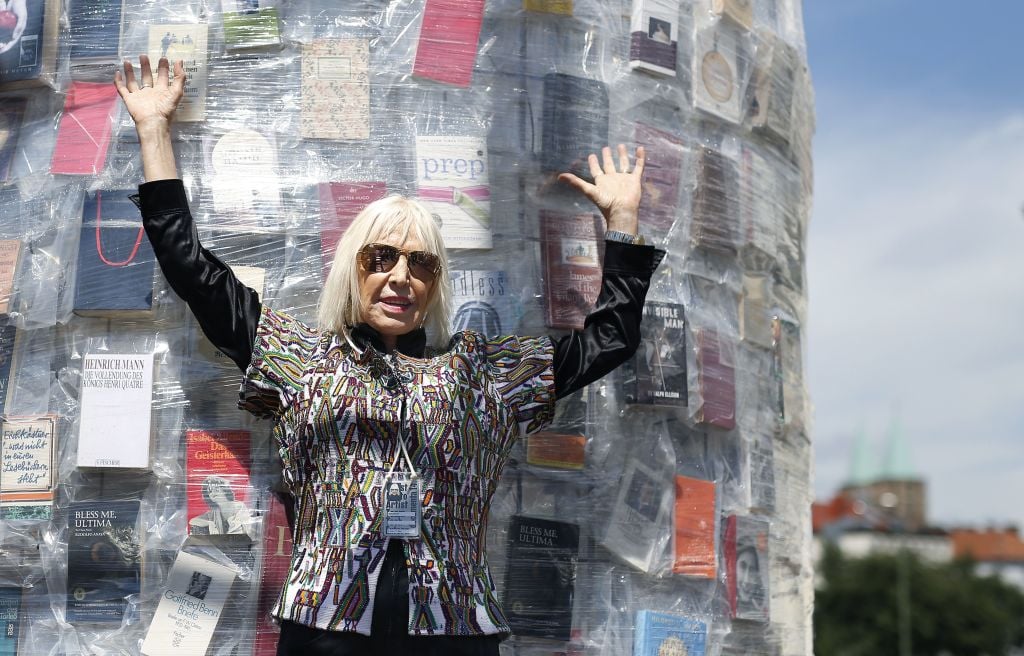 Argentinian artist Marta Minujin poses inside the 'Parthenon of Books' at the Documenta 14 art exhibition in Kassel. Photo: RONNY HARTMANN/AFP/Getty Images.