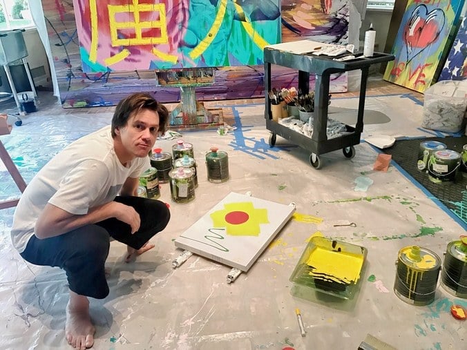Jim Carrey painting in his studio. Courtesy of the artist.