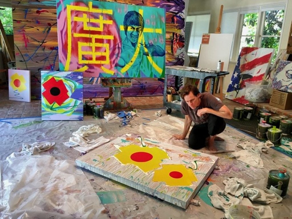 Jim Carrey painting in his studio, courtesy of the artist.