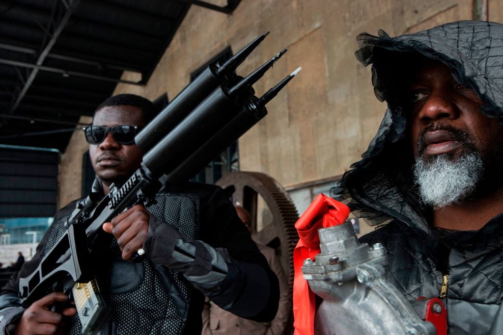 Nigerian artist Wilfred Ukpong (right) does a performance art intervention during the grand public opening of the the Zeitz Museum of Contemporary African Art in Cape Town on September 22, 2017. Photo by Rodger Bosch /AFP/Getty Images.