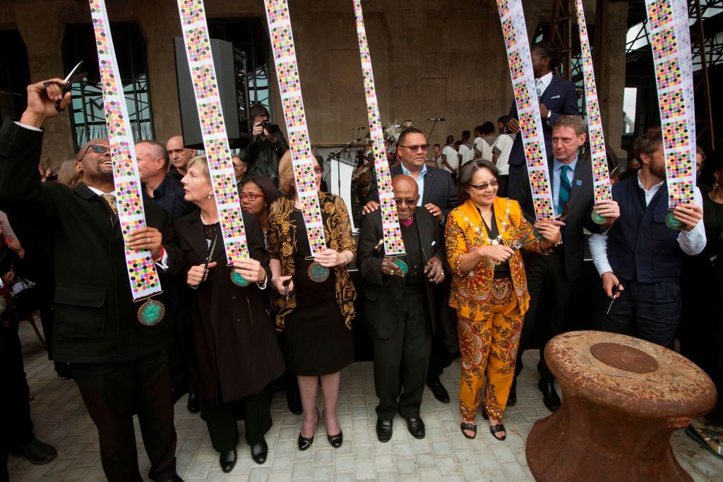 Mayor of Cape Town Patricia De Lille [third from right], former archbishop Desmond Tutu [center] and Premier of the Western Cape Province Helen Zille [third from left] prepare to cut ribbons at the grand public opening of the Zeitz Museum of Contemporary African Art in Cape Town on September 22, 2017. Photo by Rodger Bosch/AFP/Getty Images.