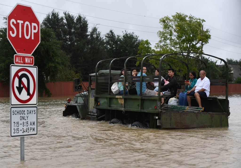 Local residents are evacuated by a military vehicle in the Clodine district after Hurricane Harvey caused heavy flooding in Houston, Texas on August 29, 2017. Photo by Mark Ralston/AFP/Getty Images.