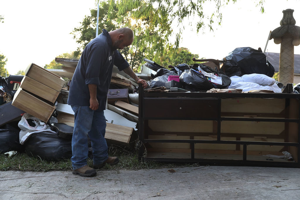 Ernesto Ramirez pauses as he cleans out his house that had been inundated with water after torrential rains caused widespread flooding during Hurricane and Tropical Storm Harvey on September 2, 2017 in Houston, Texas. Photo by Joe Raedle/Getty Images.