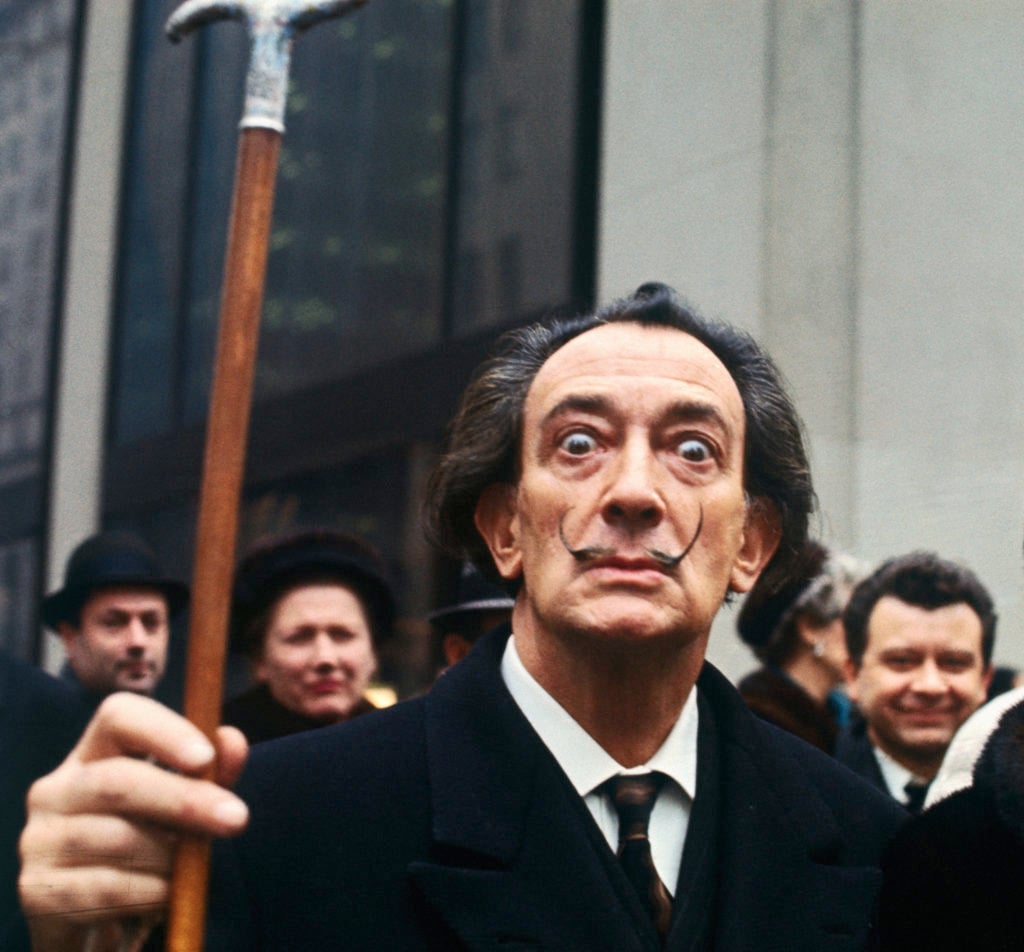 Salvador Dalí, lifting his cane on the street in New York. Image courtesy of Getty Images.