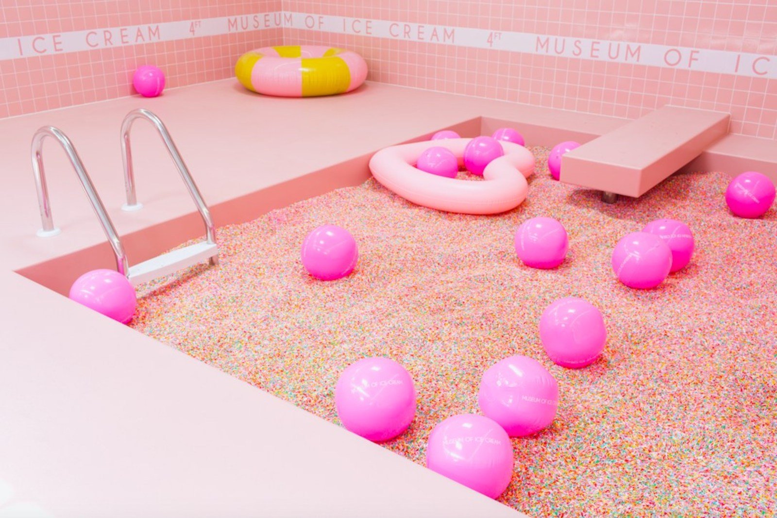 A pool in the Museum of Ice Cream filled with life-sized sprinkles