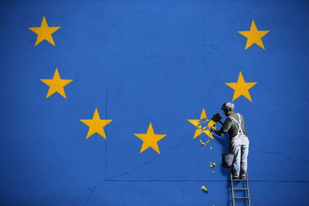 A Banksy mural depicting a workman chipping away at one of the stars on a European Union flag in Dover. Photo: Daniel Leal-Olivas/AFP/Getty Images.