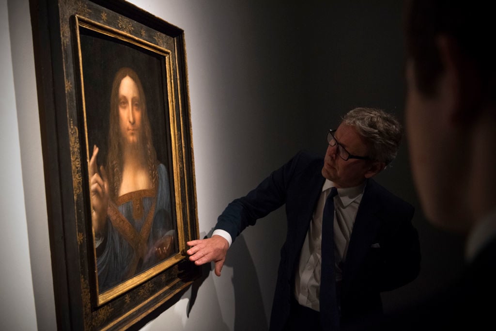 Global president of Christie's auction house Jussi Pylkkanen views a painting by Leonardo da Vinci entitled Salvator Mundi before it is auctioned in New York on November 15, at Christies on October 24, 2017 in London, England. Photo by Carl Court/Getty Images.
