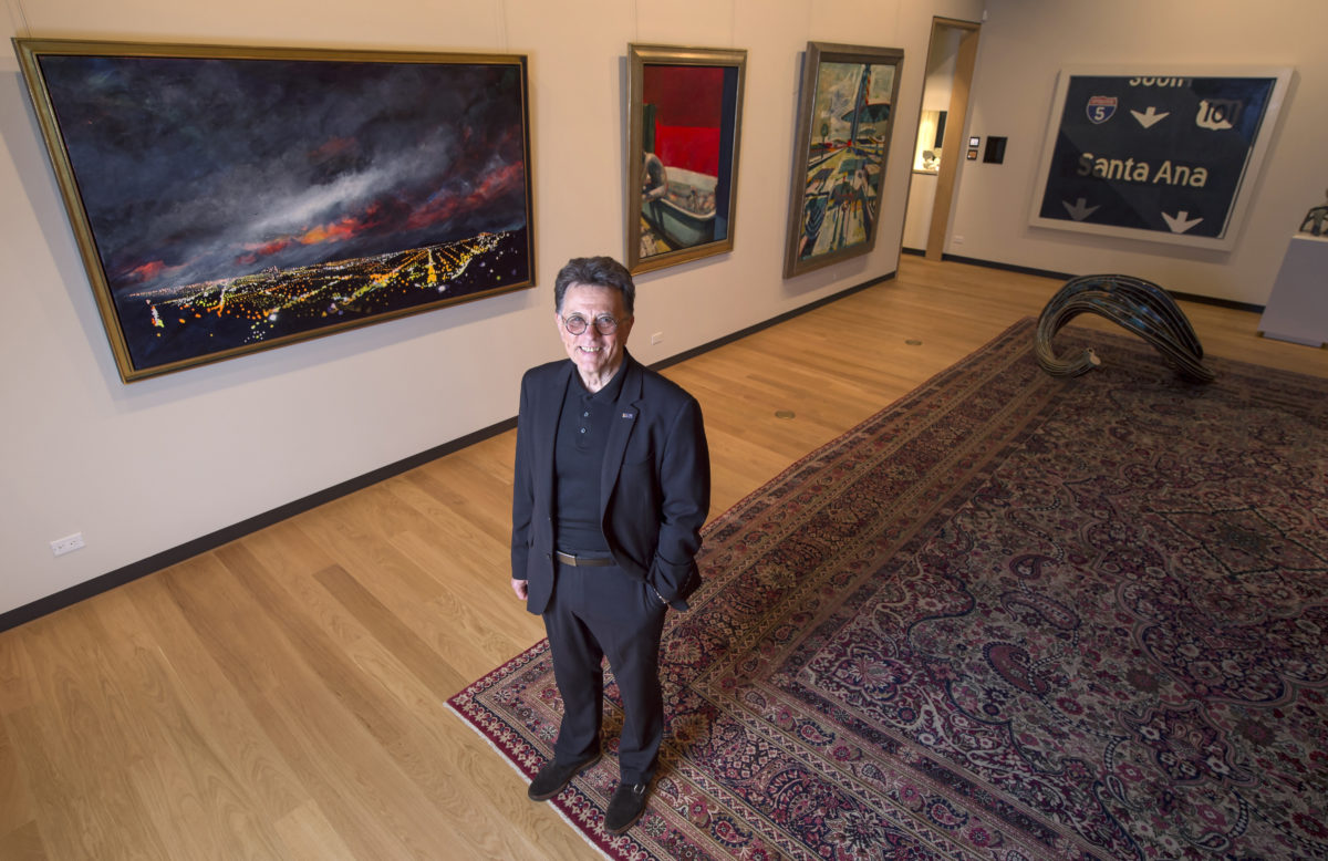 Stephen Barker, dean of the Claire Trevor School of the Arts at the University of California Irvine shows off some artworks gifted to UCI by Gerald E. Buck. Photo: Steve Zylius/UCI.