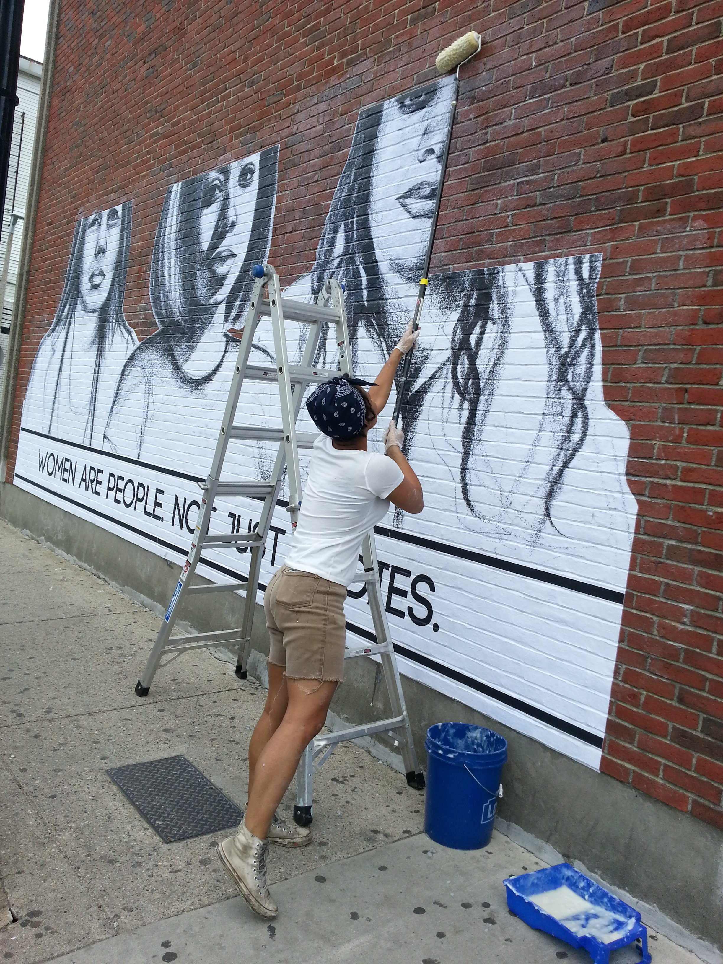 Tatyana Fazlalizadeh stalls her street campaign "Stop Telling Women To Smile" with wheat paste. Courtesy of the artist.