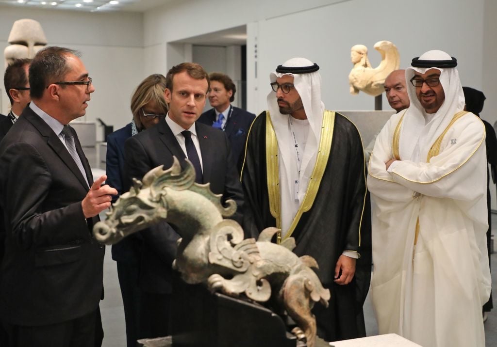 Abu Dhabi crown prince Mohammed bin Zayed Al-Nahyan (right) visits the Louvre Abu Dhabi Museum, meeting president-director of the Louvre Museum, Jean-Luc Martinez (left), French president Emmanuel Macron (second left), and chairman of Abu Dhabi's Tourism and Culture Authority, Mohamad Khalifa al-Mubarak, Deputy Director of the Louvre Abu Dhabi (second from the right) and on November 8, 2017. Photo by Ludovic Marin /AFP/Getty Images.