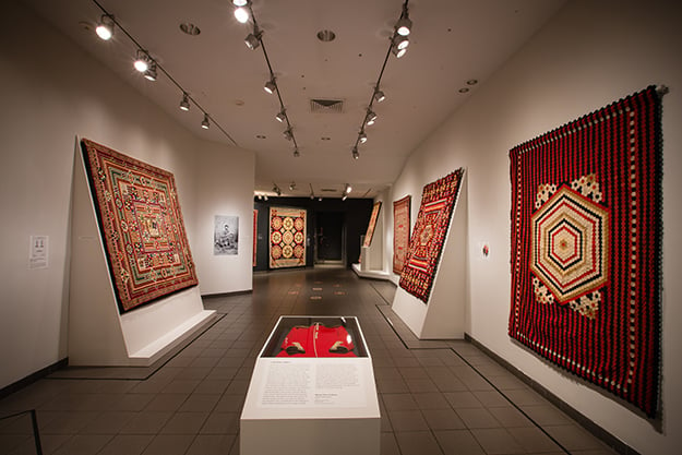 An installation view of the "War and Pieced" exhibition at the American Folk Art Museum. Photo courtesy of the American Folk Art Museum.