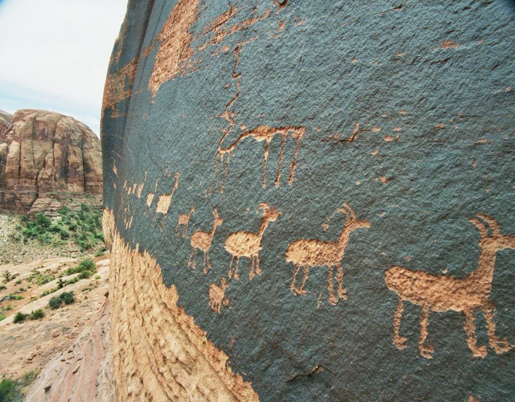 A petroglyph of a caravan of bighorn sheep near Moab, Utah. Photo by Jim Bouldin, Creative Commons Attribution-Share Alike 3.0 Unported license.