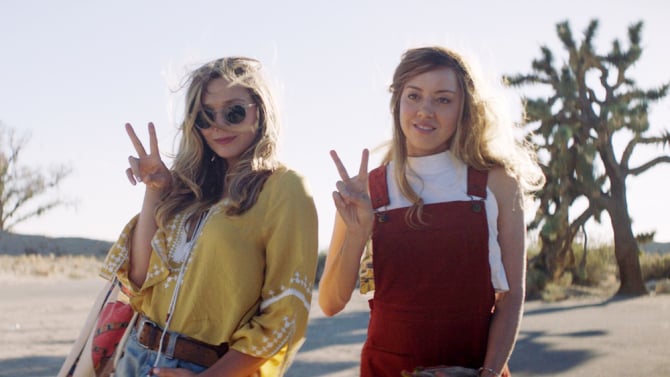 Taylor (Elizabeth Olsen) and Ingrid (Aubrey Plaza) pose for a photo in Ingrid Goes West (2017).