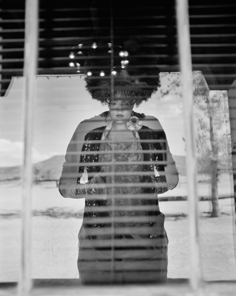 LaToya Ruby Frazier, Abigail DeVille, photographed through a motel window, part of the series "A Pilgrimage to Noah Purifoy's Desert Art Museum." Courtesy of LaToya Ruby Frazier.