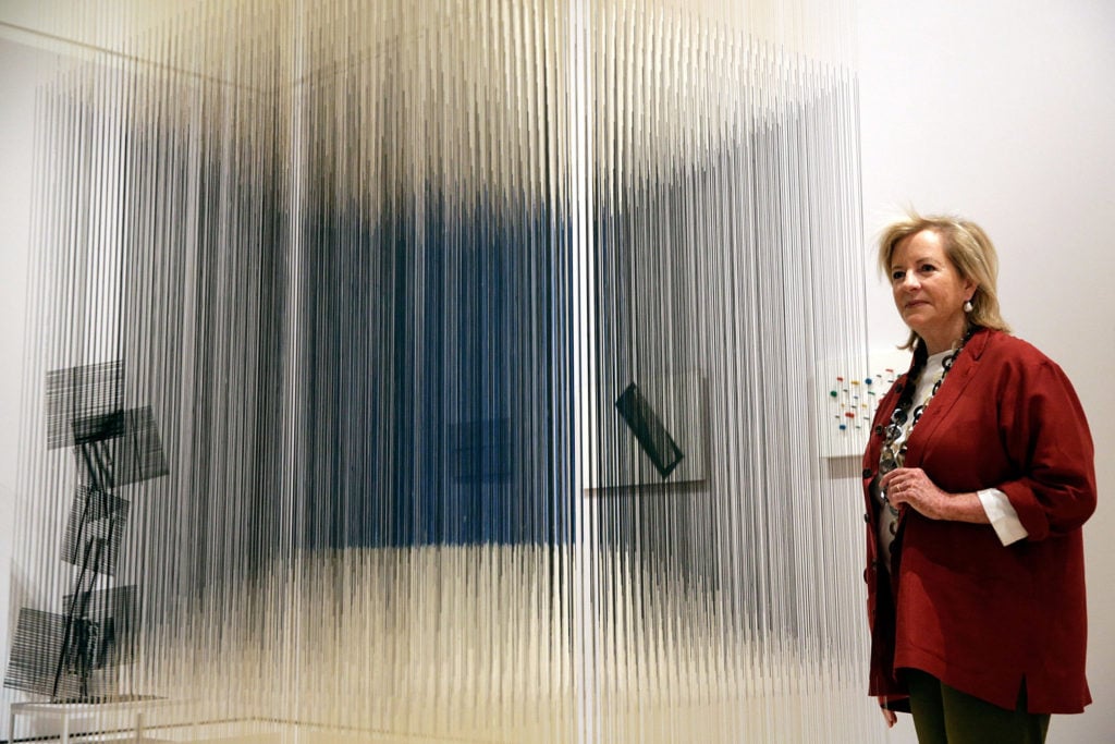 Patricia Phelps de Cisneros poses with the artwork 'Nylon Cube' by Venezuelan artist Jesus Soto, at the Royal Academy of Arts on July 1, 2014 in London, England. Photo by Matthew Lloyd/Getty Images.