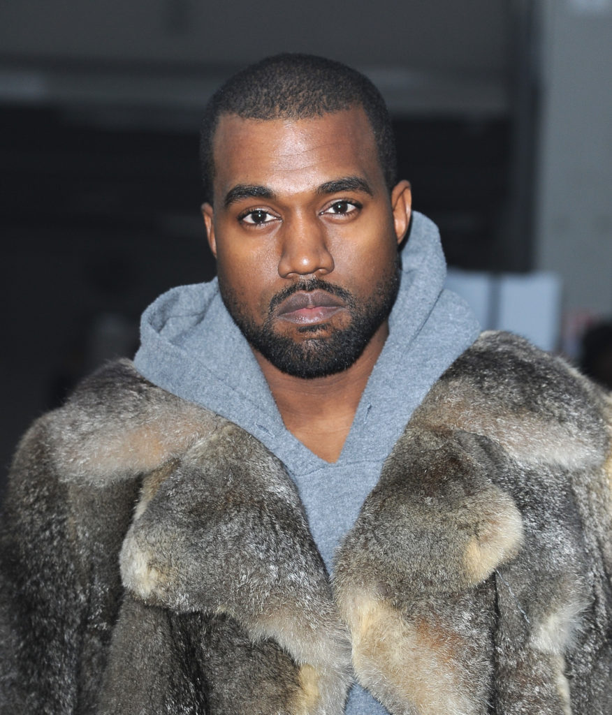 Kanye West in a fancy fur. (Photo by Pascal Le Segretain/Getty Images)
