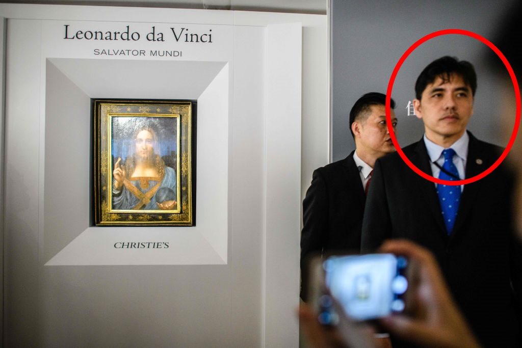 Circled, Jerry Chun Shing Lee works security at the unveiling of Leonardo da Vinci's <i>Salvator Mundi</i> on October 15, 2017, at the Christie's showroom in Hong Kong. Photo: Anthony Wallace/AFP/Getty Images.
