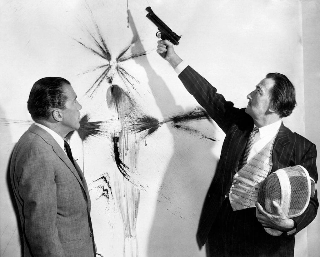Picture dated in the 60s of TV American presenter Ed Sullivan (left) looking at Spanish artist Salvador Dali showing how to paint with a spray gun. Photo courtesy AFP/GettyImages.