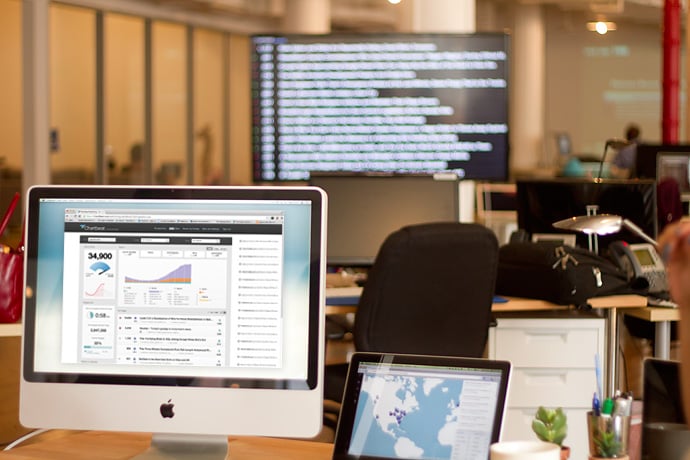 Promotional image showing Chartbeat in use in an office. Image courtesy Chartbeat.