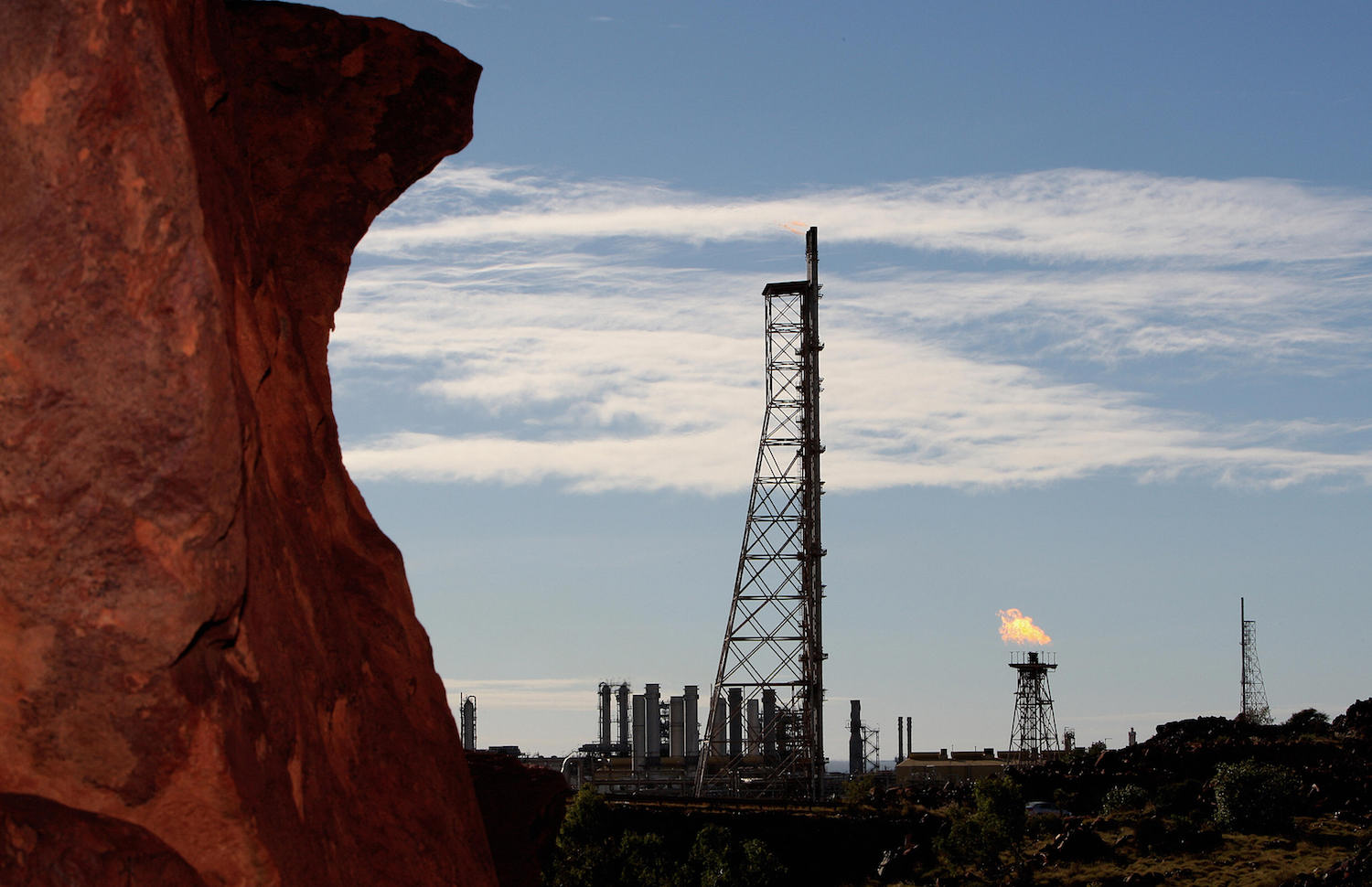 Gas flares at an industrial site on the Burrup Peninsula, home to perhaps one million pieces of Aboriginal rock engravings several thousands of years old. Photo courtesy Greg Wood/AFP/Getty Images.