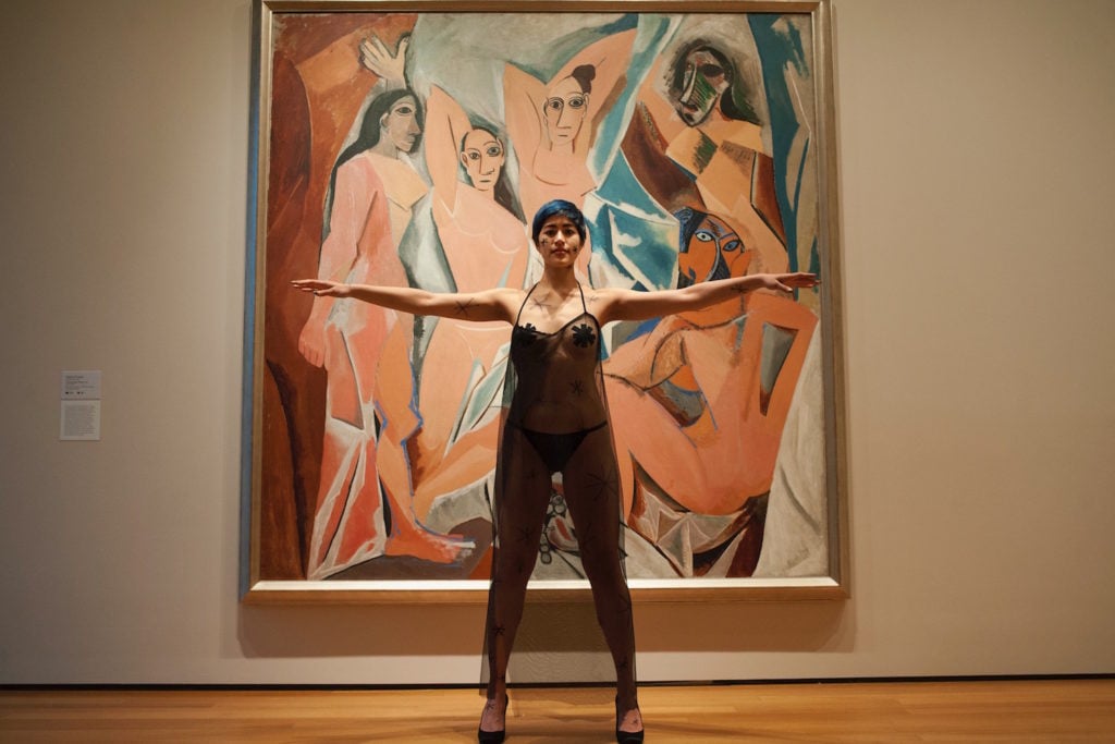 Emma Sulkowicz's protest performance, with Pablo Picasso's <Em>Les Demoiselles d'Avignon</em> at the Museum of Modern Art. Photo courtesy of Sangsuk Sylvia Kang.