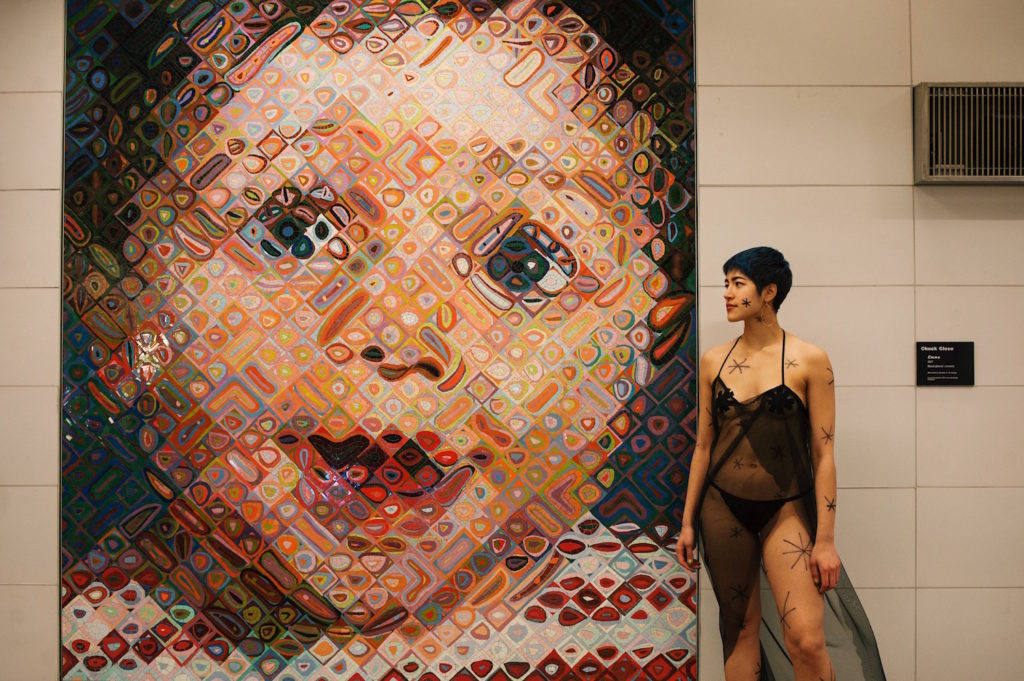 Emma Sulkowicz's protest performance, with a Chuck Close mosaic at the 2nd Avenue subway 86th Street station. Photo courtesy of Sangsuk Sylvia Kang.