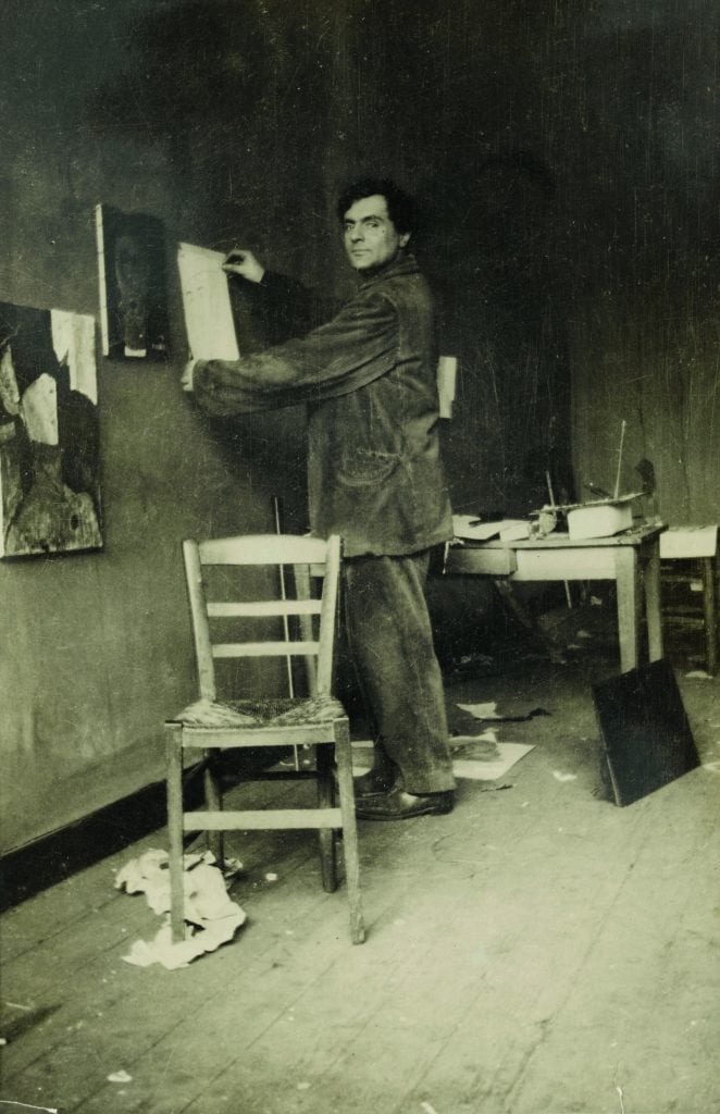 Modigliani in his studio in a photograph by Paul Guillaume from around 1915. ©RMN-Grand Palais (musée de l’Orangerie) I Archives Alain Bouret. Image: Dominique Couto.