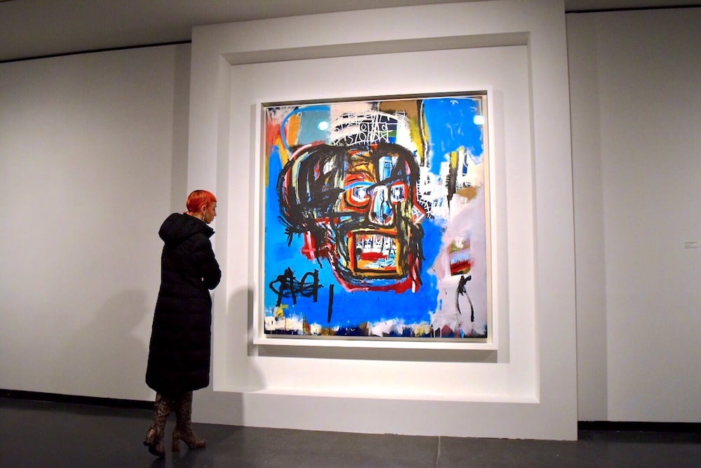 A visitor contemplates Jean-Michel Basquiat's Untitled (1982) at the Brooklyn Museum.