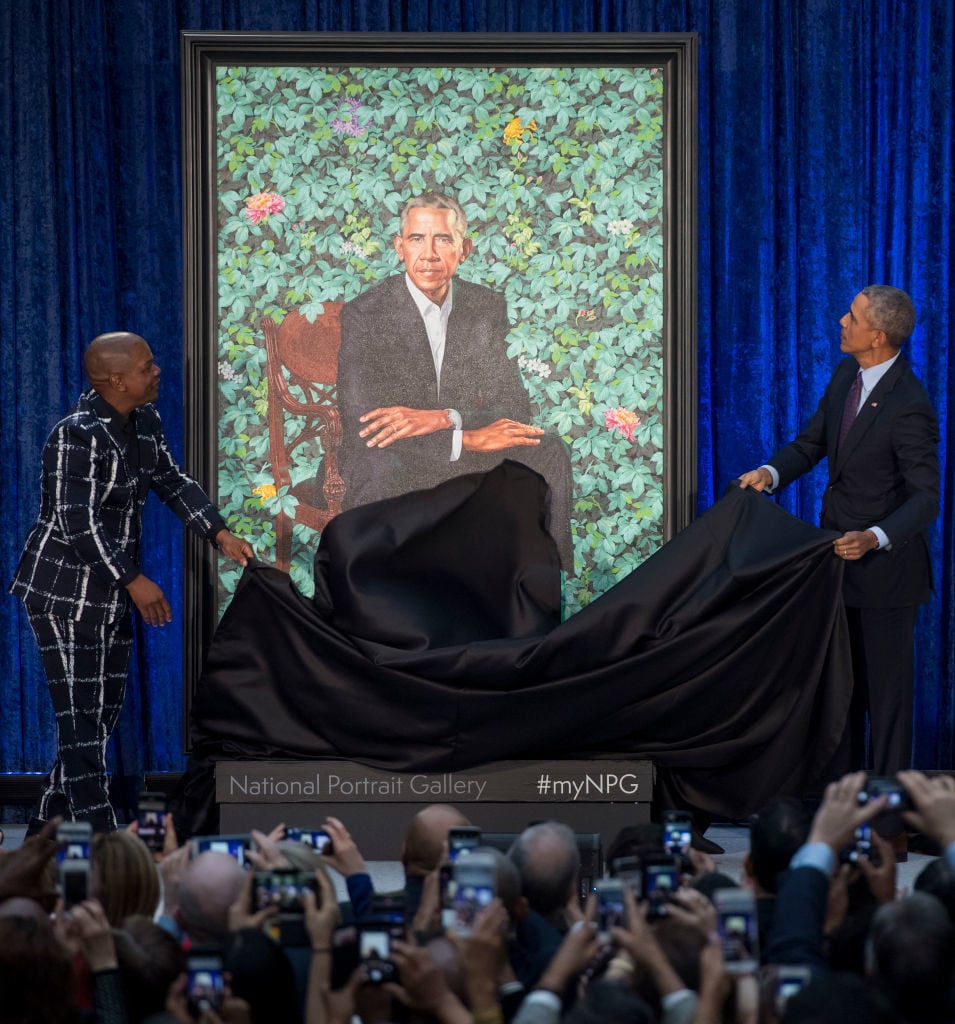Former US President Barack Obama unveils his portrait alongside the portrait's artist, Kehinde Wiley, at the Smithsonian's National Portrait Gallery in Washington, DC. Photo credit should read Saul Loeb/AFP/Getty Images.