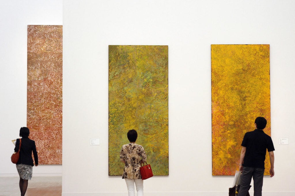 Visitors admire paintings during the opening of Emily Kame Kngwarreye's exhibition at the National Art Center in Tokyo on May 27, 2008. Photo courtesy of Ken Shimizu/AFP/Getty Images.