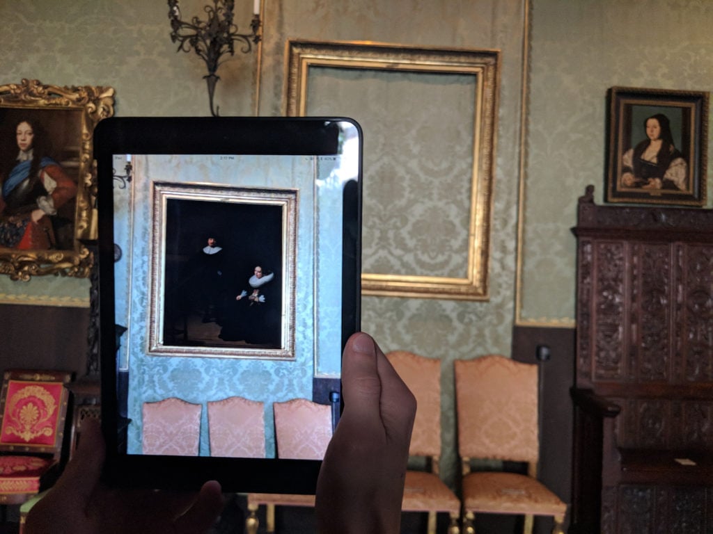 One of the Isabella Stewart Gardner Museum paintings stolen in 1990, Rembrandt van Rijn's <em>A Lady and Gentleman in Black</em>, returned to its frame through the magic of augmented reality. Photo courtesy of the Cuseum. 