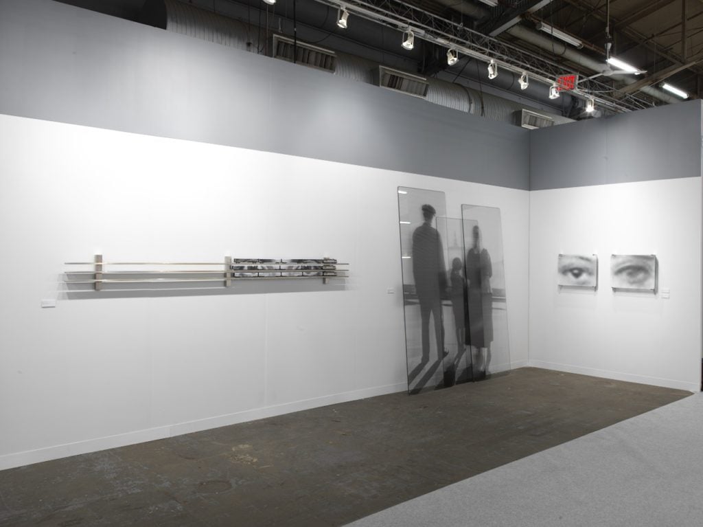 Installation view of JR's booth with Jeffrey Deitch at the Armory Show. Photo courtesy of Jeffrey Deitch, Inc. 