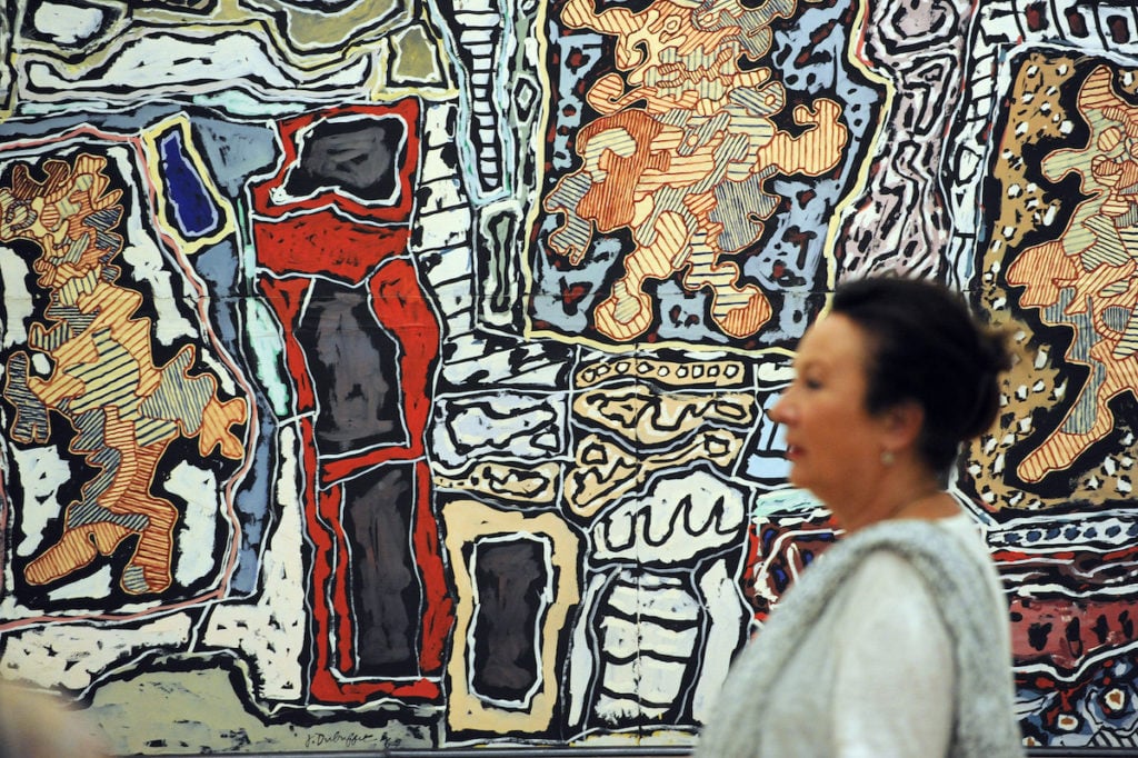 A visitor passes by <em>Continuum de ville</em>Jean Dubuffet at the Granet museum in Aix-en-Provence, southern France. Photo courtesy Gerard Julien/AFP/Getty Images.