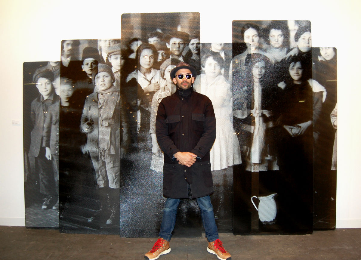 JR with his work, shown by Jeffrey Deitch, at the Armory Show. Photo courtesy of Sarah Cascone