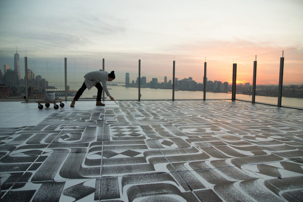 Romon K. Yang creating a rooftop work. Photo courtesy of Arts Brookfield. 