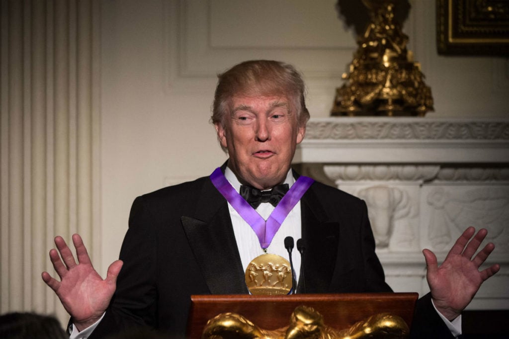 President Donald J. Trump awards himself the National Medal of the Arts, the nation's highest honor in arts and letters. Image courtesy Nicholas Kamm/AFP/Getty Images.