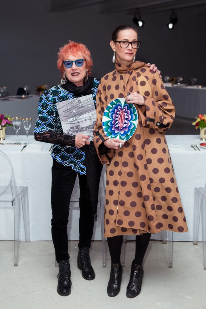 Judy Chicago with her new book, her gallerist, Jeanne Greenberg Rohatyn, and one of her new plates from the Prospect NY. Photo courtesy of BFA.