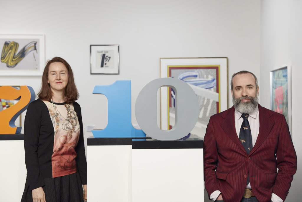 Kelly Troester and Cary Leibowitz, heads of the prints department at Phillips, which they founded ten years ago, with some of the Robert Indiana number sculptures in the upcoming print sale at Phillips. Photo courtesy of Phillips.