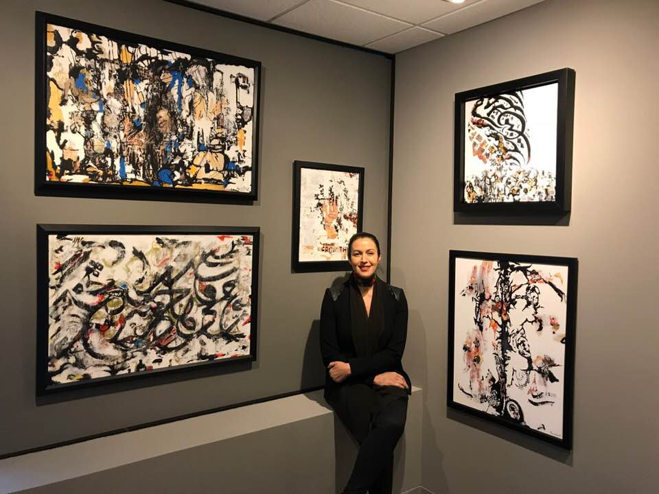 Manal Deeb with the “From There to Here” exhibit at Palestine Museum US. Photo courtesy of the Palestine Museum US.
