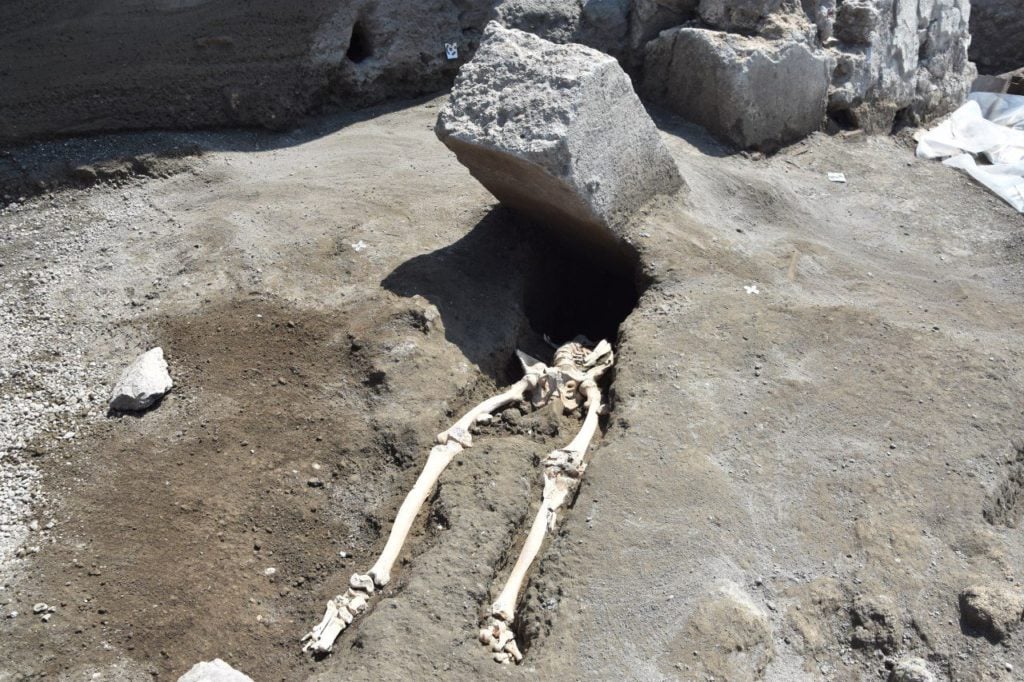 This skeleton of a man killed by a falling rock while fleeing the eruption of Vesuvius was recently discovered at the archaeological site of Pompeii. Photo courtesy of the Soprintendenza Archeologica di Pompei.