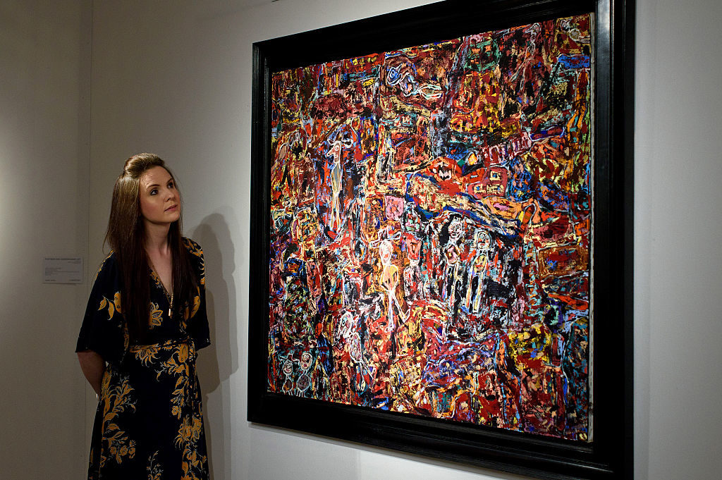 A guest views <em>Cote Chipote</em> by artist Jean Dubuffet during the preview ahead of Christie's New York post war and contemporary art sale on October 9, 2015 in London, England. Photo by Ben Pruchnie/Getty Images.
