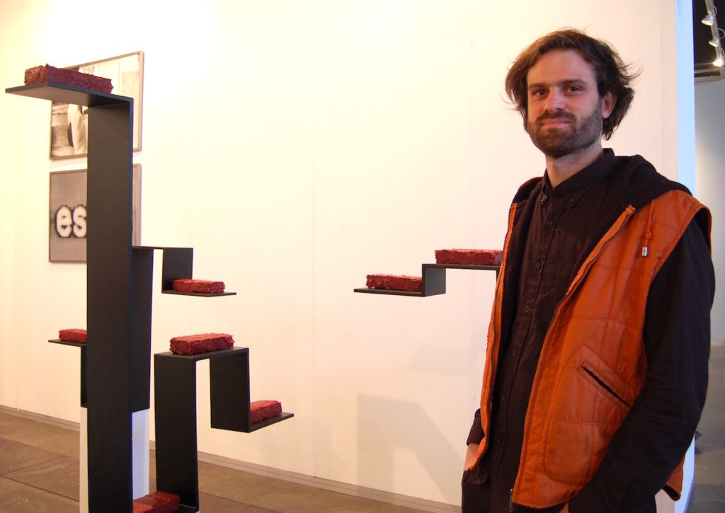 Martín Touzón with is work <em>Component [Destierro]</em> at El Mirador Arte Contemporáneo from Buenos Aires at ArteBA. Photo by Sarah Cascone.