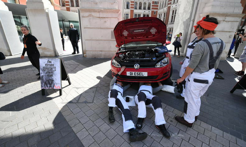 Female mechanics from Greenpeace take apart a diesel car outside the Victoria & Albert Museum, where VW is currently sponsoring the exhibition 
